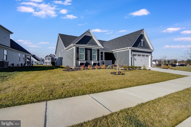 view of front of home with a front yard and a garage