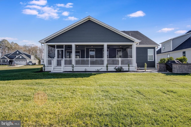 view of front of home featuring a sunroom and a front lawn