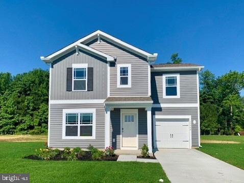 view of front of home with a front yard and a garage