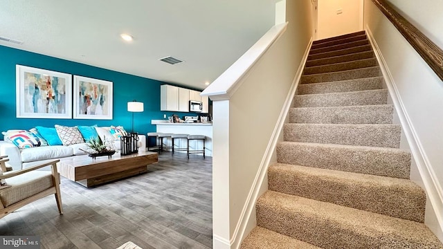 staircase featuring wood-type flooring