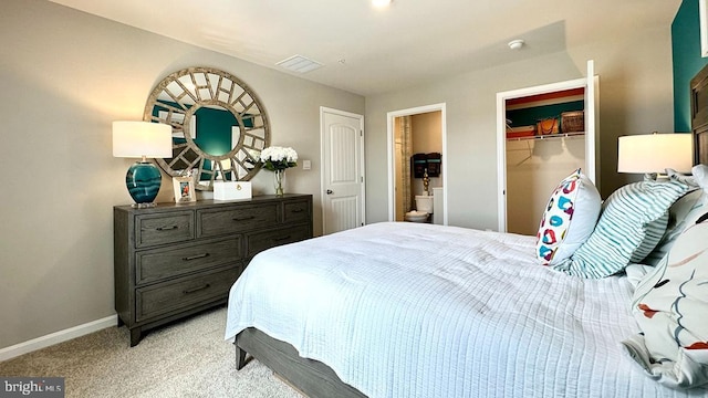 bedroom with light carpet and a closet