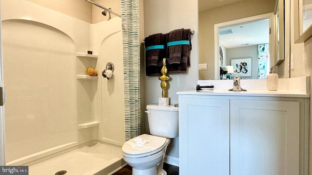 bathroom with vanity, toilet, and walk in shower