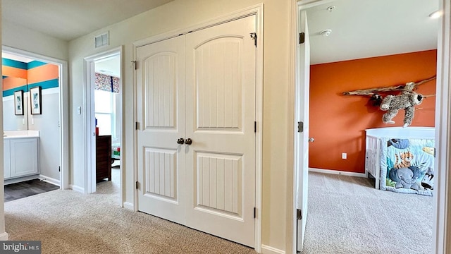 hallway featuring carpet flooring