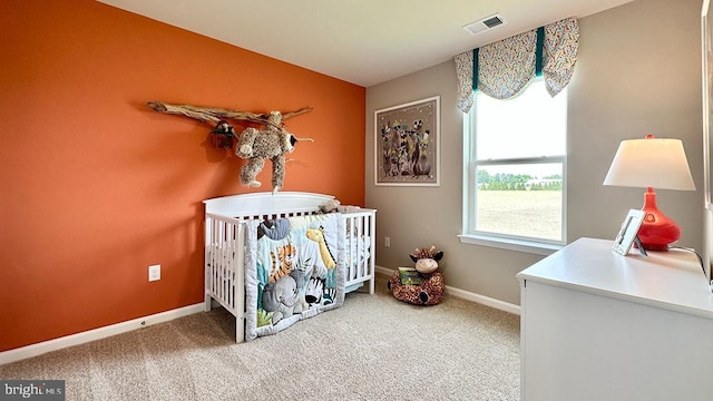 bedroom featuring carpet, vaulted ceiling, and a nursery area