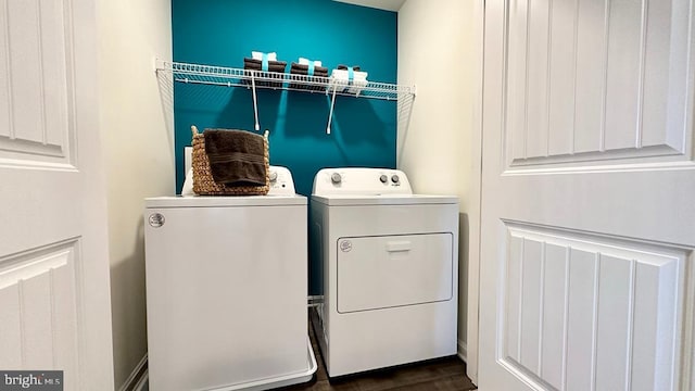 laundry room featuring washer and clothes dryer and dark wood-type flooring