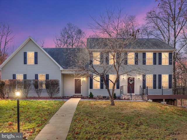 colonial inspired home featuring a lawn