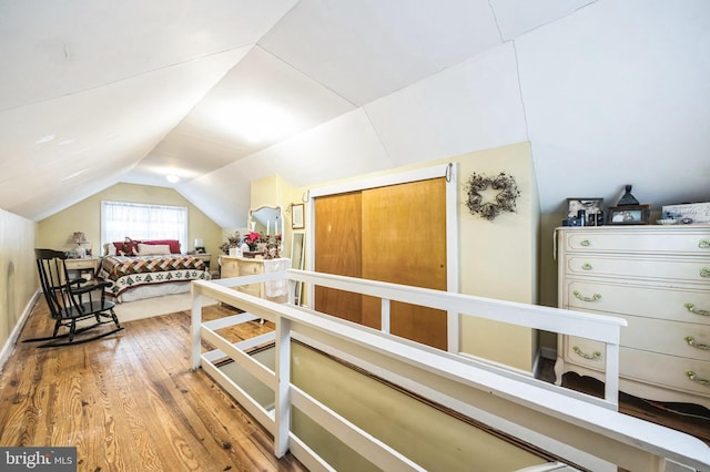 bedroom featuring hardwood / wood-style floors and lofted ceiling