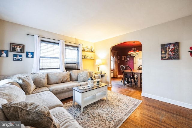 living room featuring hardwood / wood-style flooring and an inviting chandelier