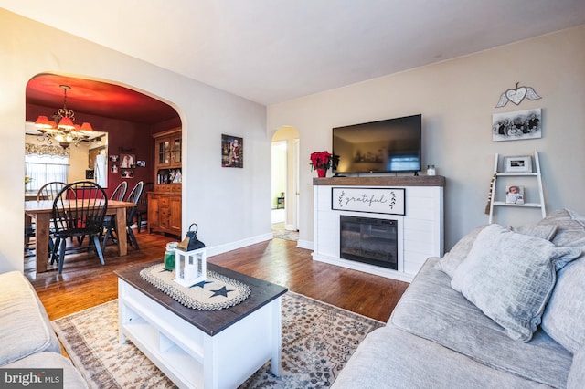 living room featuring hardwood / wood-style floors and a notable chandelier