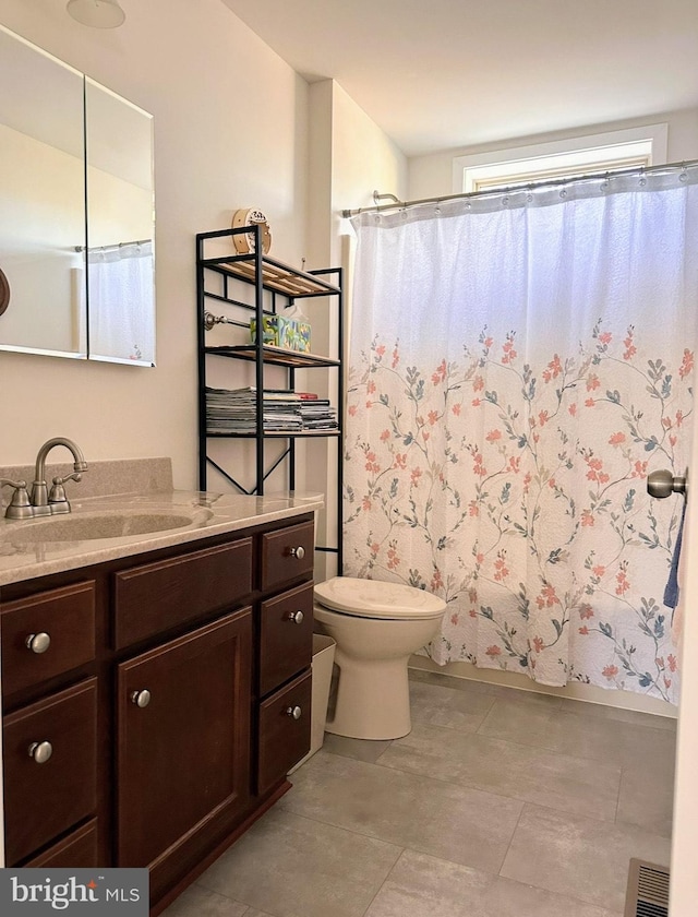 full bathroom with vanity, shower / bath combination with curtain, and toilet