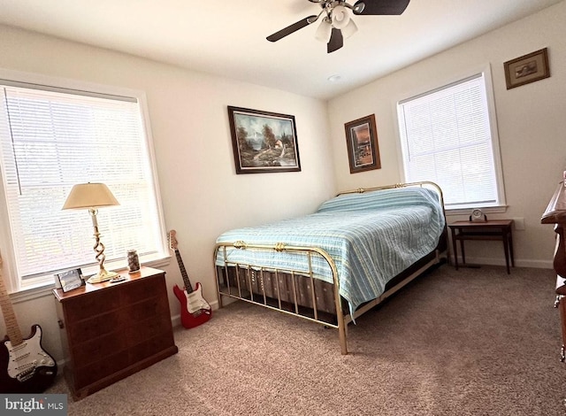 carpeted bedroom with multiple windows and ceiling fan