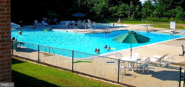 view of swimming pool featuring a patio area