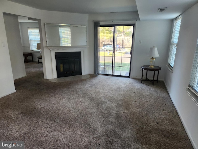 unfurnished living room featuring carpet