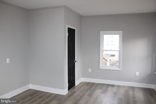 spare room with hardwood / wood-style flooring and ornamental molding