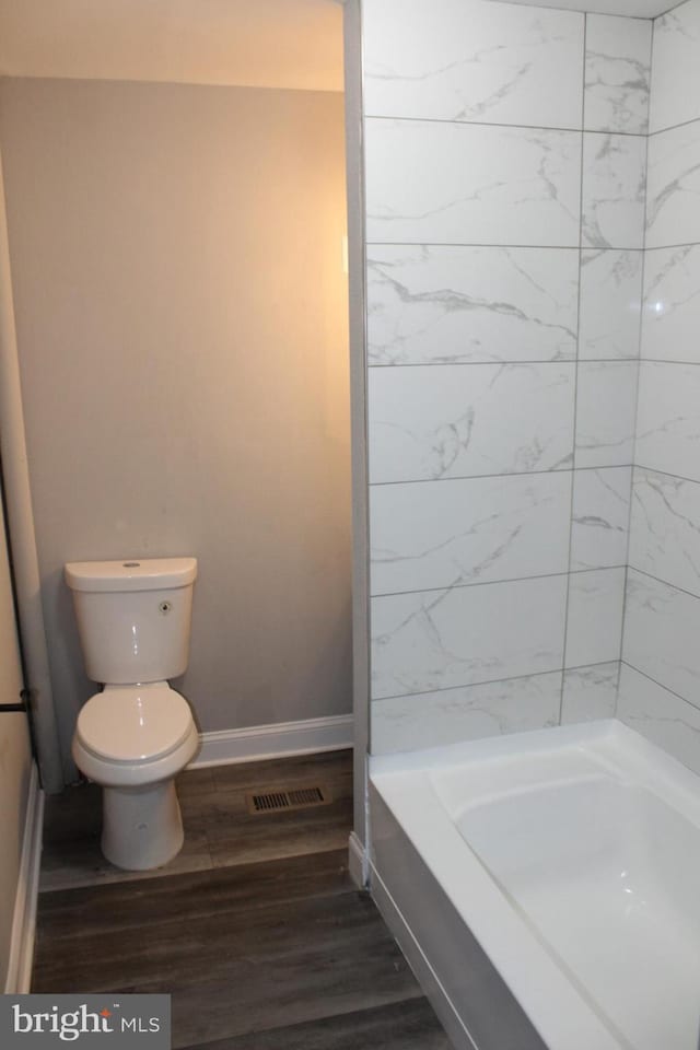 bathroom featuring hardwood / wood-style floors and toilet