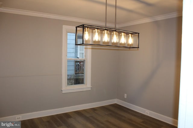 unfurnished dining area featuring dark hardwood / wood-style floors and crown molding