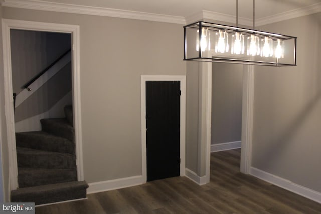 unfurnished dining area featuring dark hardwood / wood-style floors and ornamental molding