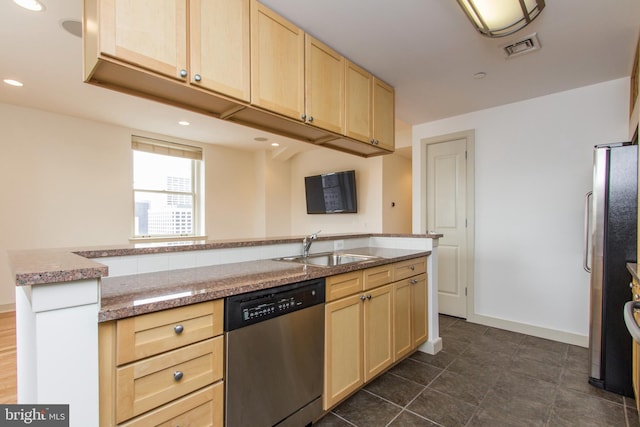 kitchen featuring appliances with stainless steel finishes, light brown cabinetry, sink, a center island with sink, and dark tile patterned flooring