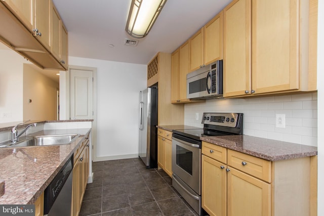 kitchen with light brown cabinetry, sink, and stainless steel appliances