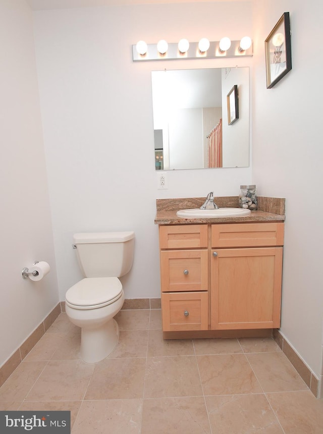 bathroom with tile patterned floors, vanity, and toilet