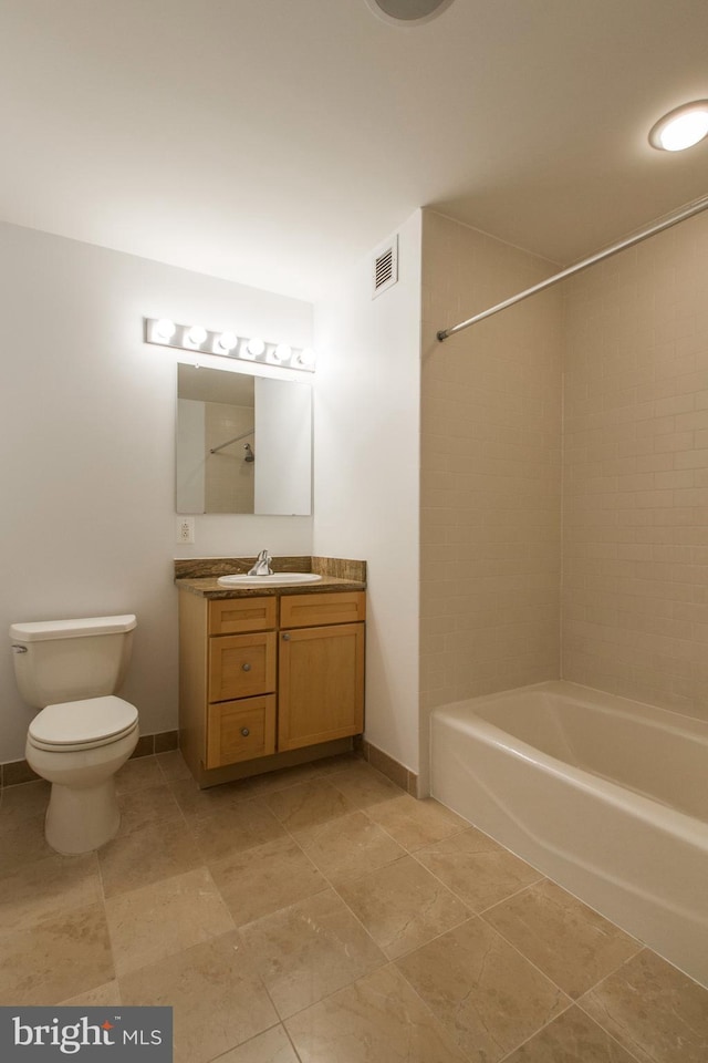 full bathroom featuring tile patterned flooring, vanity, toilet, and tiled shower / bath combo