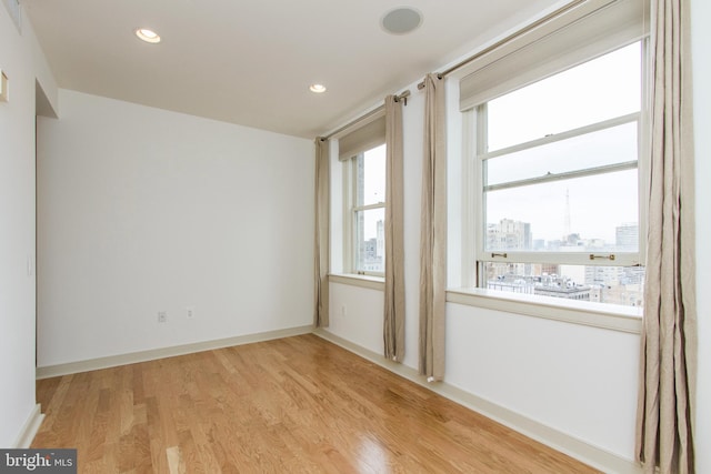 empty room with plenty of natural light and light wood-type flooring