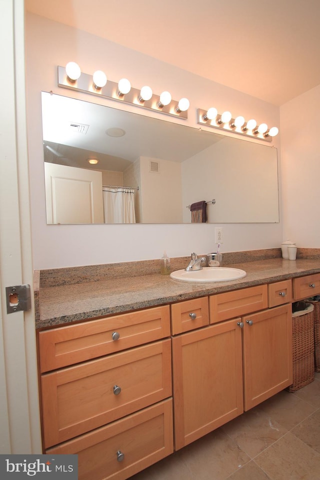 bathroom featuring tile patterned flooring and vanity