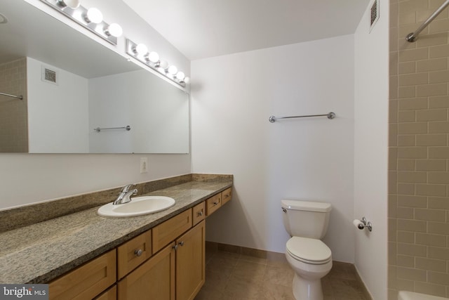 bathroom featuring tile patterned floors, vanity, and toilet