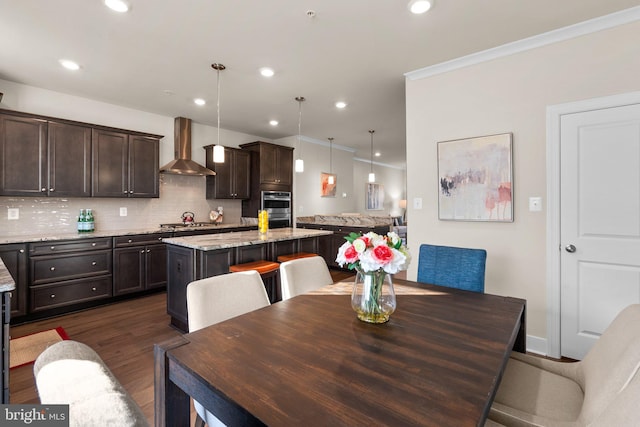 dining area featuring dark hardwood / wood-style flooring and ornamental molding