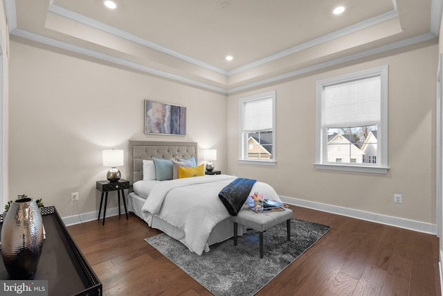 bedroom with crown molding, dark wood-type flooring, and a tray ceiling