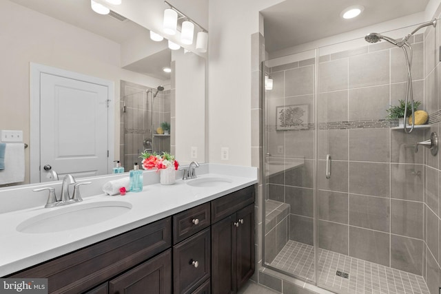 bathroom featuring vanity and a shower with shower door