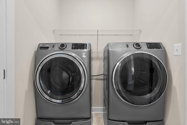 clothes washing area with separate washer and dryer