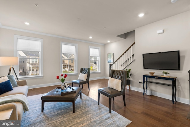 living room with crown molding and dark hardwood / wood-style flooring