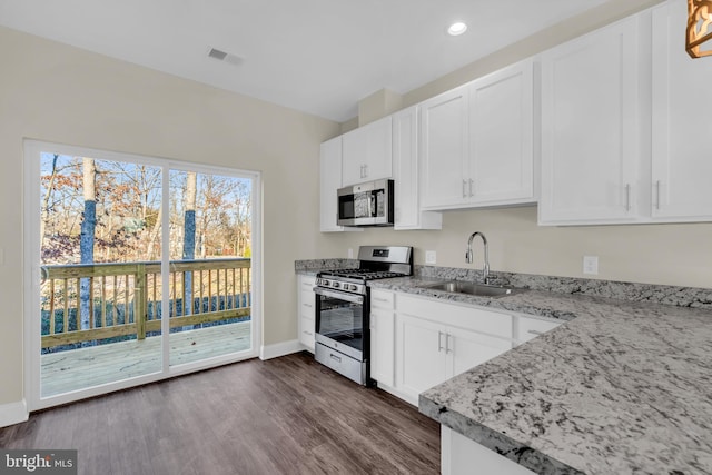14 Mill Creek Ct, Bayville, NJ 08721 - kitchen featuring appliances with stainless steel finishes, a sink, baseboards, dark wood-style floors, and light stone counters
