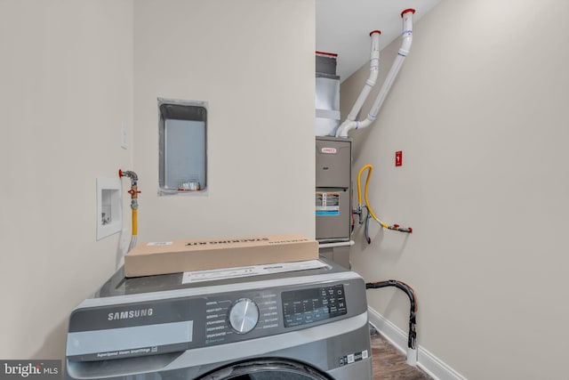 laundry area with dark hardwood / wood-style floors and washer / dryer