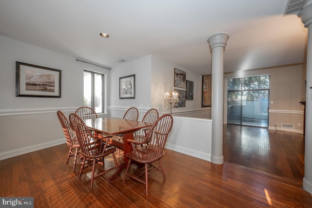 dining area with ornate columns and dark wood-type flooring