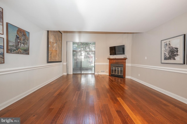 unfurnished living room with dark hardwood / wood-style floors