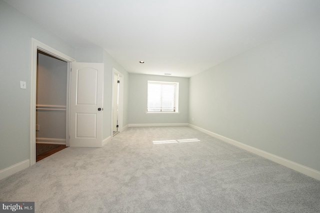 unfurnished bedroom featuring light carpet