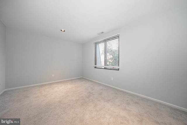 empty room featuring light carpet