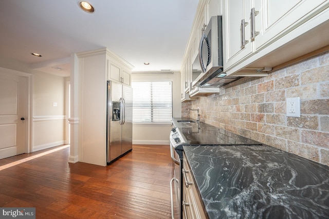 kitchen featuring white cabinets, dark hardwood / wood-style floors, stainless steel appliances, and tasteful backsplash