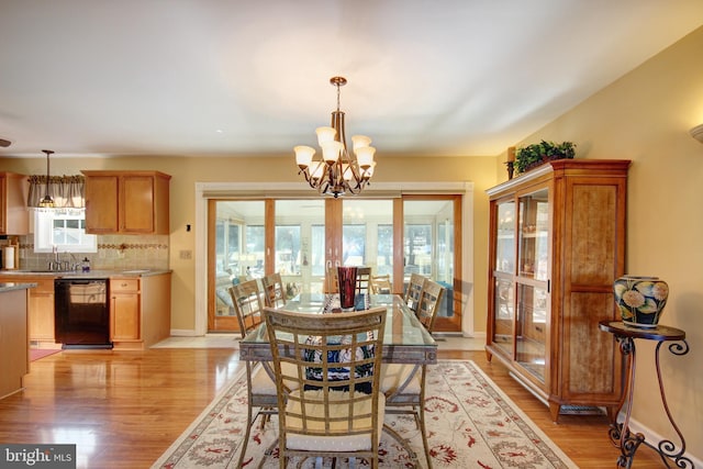 dining room featuring light hardwood / wood-style floors and a chandelier