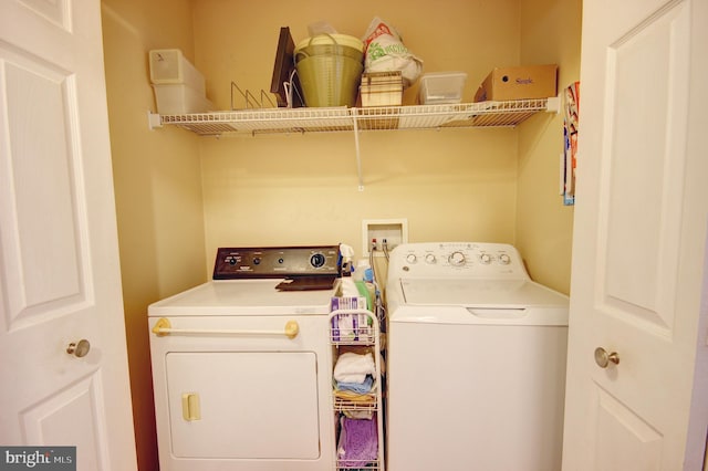 clothes washing area with washing machine and clothes dryer