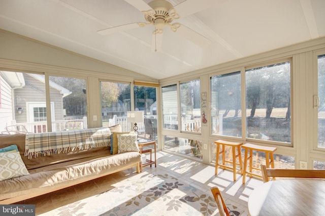 sunroom / solarium with ceiling fan, a healthy amount of sunlight, and vaulted ceiling