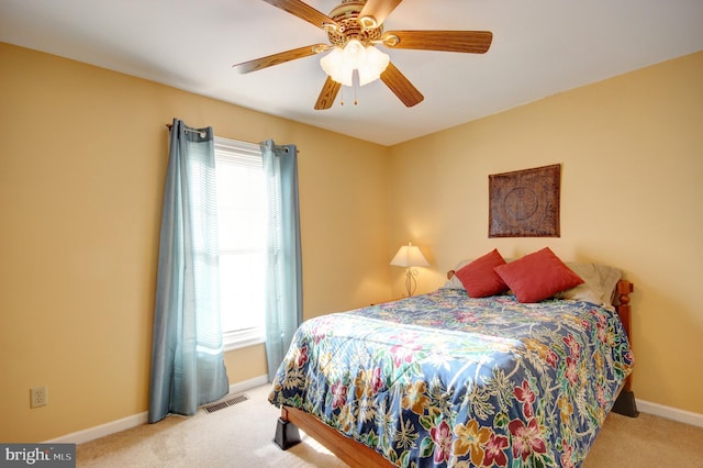 bedroom with ceiling fan and light carpet