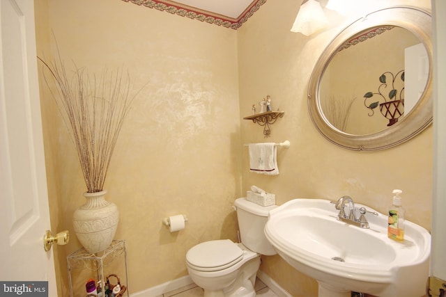 bathroom featuring tile patterned floors, sink, and toilet