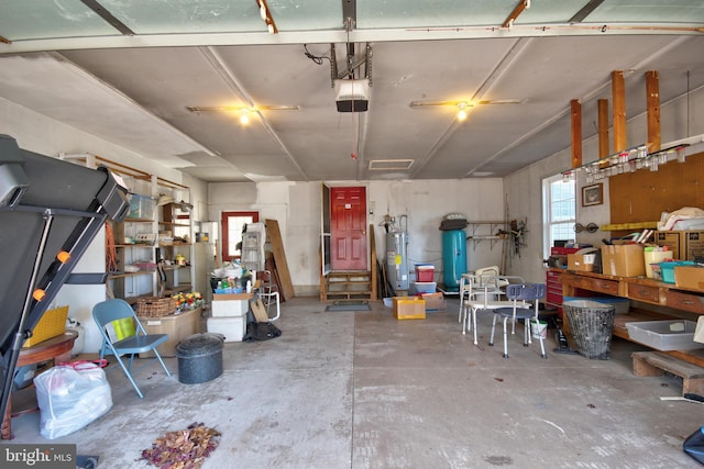 garage with electric water heater and a garage door opener