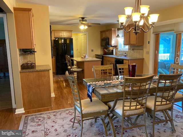 dining room featuring hardwood / wood-style flooring, a healthy amount of sunlight, and sink