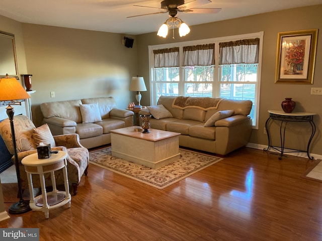 living room featuring ceiling fan and hardwood / wood-style floors