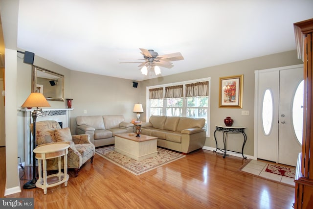 living room with hardwood / wood-style floors and ceiling fan