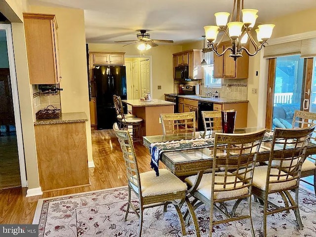 dining space with light wood-type flooring, plenty of natural light, and sink